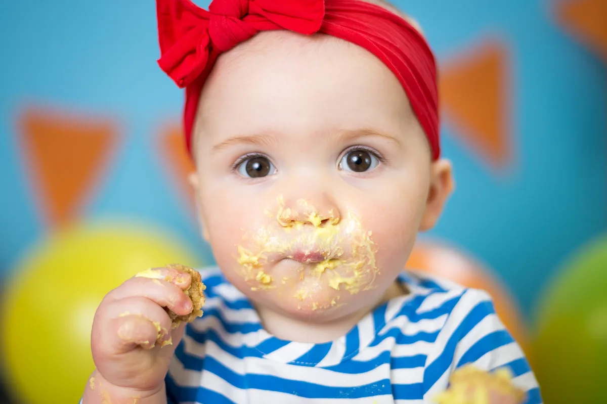 Baby with a yellow smash cake and sunshine-themed birthday setup at a Chicago photography studio