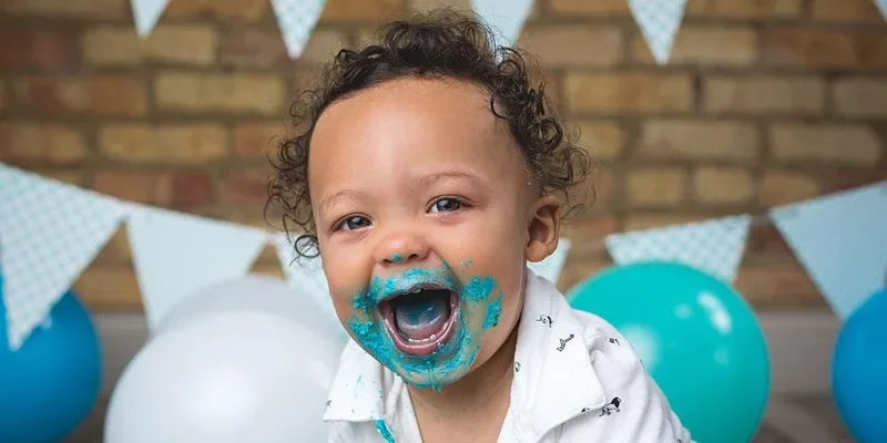 Baby enjoying a cake smash mini session at our Edgewater studio