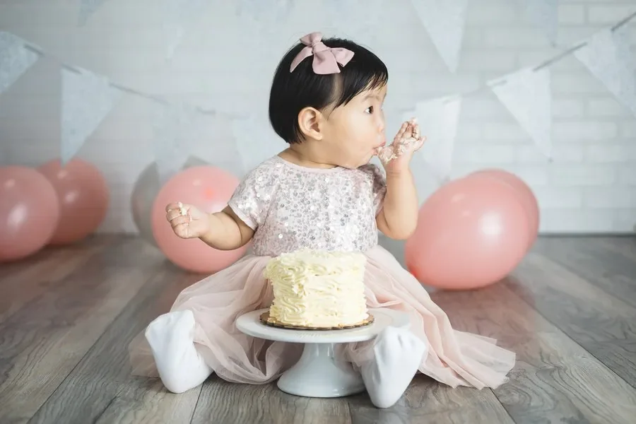 Baby enjoying a cake smash photography session in our Chicago studio